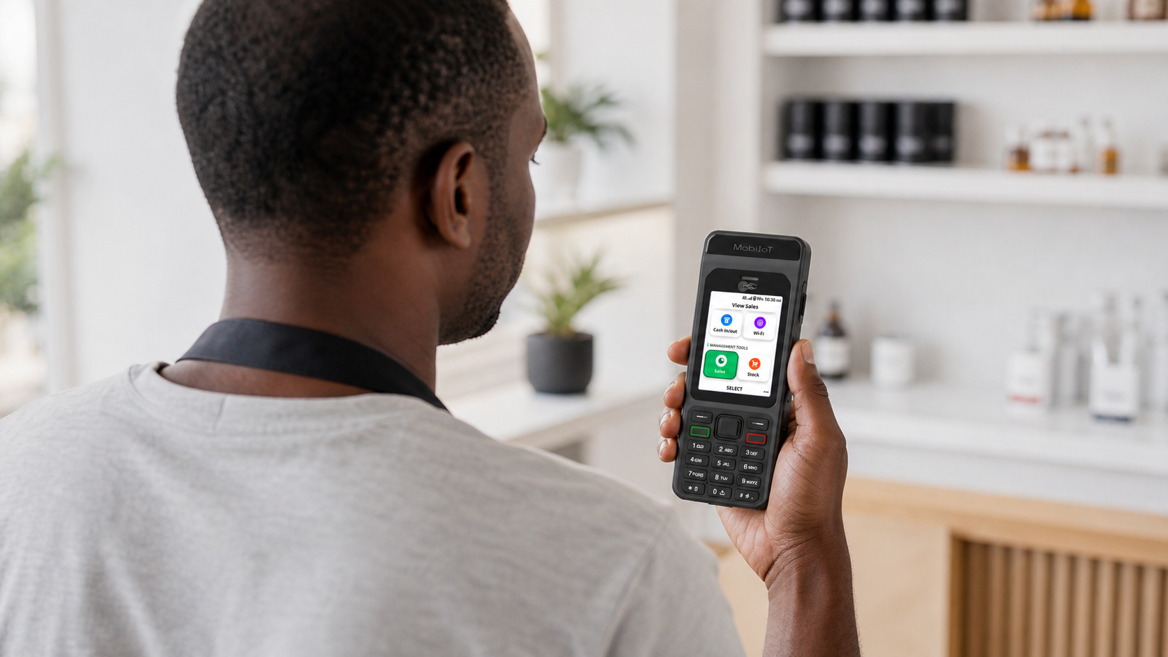 Merchant using the KaiOS merchant app on a MobiTap Mini device